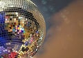 Shiny mirror ball with colorful highlights at the disco