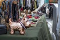 A shiny model of a Scottish Terrier stands on a table of pet supplies.