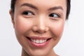 Woman with shiny and natural makeup smiling broadly