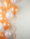 Shiny orange and white balloons on neutral light gray background with copy space. Festive background. Generative AI,