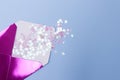 Shiny pink envelope with glitter confetti in a form stars on a blue background. Festive concept Royalty Free Stock Photo