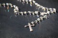 Shiny and pretty Rosary on a black surface. Cross and Hail Mary Pendant.