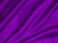 Shiny purple crumpled fabric texture. Elegant wavy cloth background