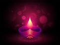 Shiny purple lit oil lamp on blurred floral background for Diwali festival celebration concept. Royalty Free Stock Photo