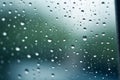 Shiny raindrops splashes falling cascading down wet glossy foggy glass window car outdoor during rainy stormy day Royalty Free Stock Photo