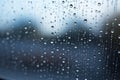 Shiny raindrops splashes falling cascading down wet glossy foggy glass window car outdoor during rainy stormy day Royalty Free Stock Photo