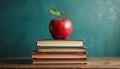 Shiny red apple with green leaf sits on vintage stacked books. Image represents school, learning, knowledge, wisdom, study. Royalty Free Stock Photo