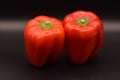 Shiny Red Bell Peppers on Black Royalty Free Stock Photo