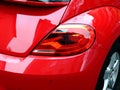 shiny red car tail light detail with bumper and aluminum rim Royalty Free Stock Photo