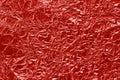 Shiny red foil texture background, pattern of wrapping paper with crumpled and wavy Royalty Free Stock Photo