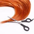 Shiny red hair and hair cutting shears