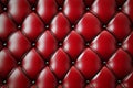 Shiny red leather upholstery forming a diamond pattern, decorated with metallic buttons, creates a luxurious and elegant Royalty Free Stock Photo