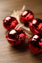 Shiny red sleigh bells on wooden table, closeup Royalty Free Stock Photo