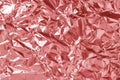 Shiny rose gold foil texture background, pattern of red pink wrapping paper with crumpled and wavy