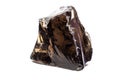 Shiny semi-transparent uncut real black obsidian volcanic glass crystal Royalty Free Stock Photo