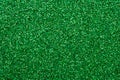 Shiny sequin fabric. Sparkle green texture, dark glitter background. Shimmering surface of textile. Abstract glister pattern.