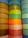 Shiny silk ribbons on shelf in store. Homemade concept. Multicolored ribbons in fabric and needlework store.