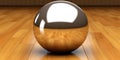 a shiny silver ball on a wooden floor
