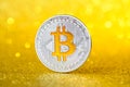 Shiny silver bitcoin coin. Golden bitcoin symbol on golden shiny glitter