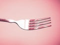 Shiny silver fork close-up in pink space Royalty Free Stock Photo