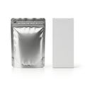 Shiny silver pouch standing upright next to a gray rectangular box Royalty Free Stock Photo