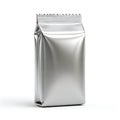 A shiny, silver, rectangular pouch with a crimped top, standing upright against a white background Royalty Free Stock Photo
