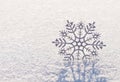 Shiny silver snowflake on brilliant snow, winter Christmas concept background Royalty Free Stock Photo