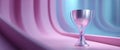 Shiny silver trophy cup placed on smooth surface with futuristic curved background in soft pink and blue lighting Royalty Free Stock Photo