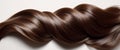Shiny and smooth brown hair displayed in a wave pattern on a light background Royalty Free Stock Photo