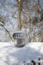 Whirlybird Air Vent on a Snowed-Over Roof Royalty Free Stock Photo