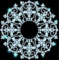 Shiny snowflake made of precious stones on black background