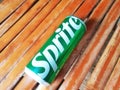 Shiny Sprite can on an old bamboo background, green aluminum can from a popular soft drink brand