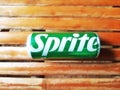 Shiny Sprite can on an old bamboo background, green aluminum can from a popular soft drink brand