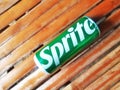 Shiny Sprite can on an old bamboo background, green aluminum can from a popular soft drink brand