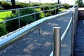 Shiny stainless steel guard and handrail along paved handicap ramp Royalty Free Stock Photo