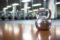 a shiny stainless steel kettlebell on a gym floor