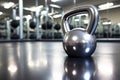 a shiny stainless steel kettlebell on a gym floor