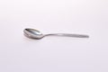 Shiny stainless steel spoon on a white solid backround