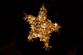 Shiny star made of electric garland as a Christmas decoration isolated on black