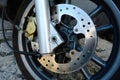 Shiny steel front brake disc detail on scooter or motorcycle Royalty Free Stock Photo