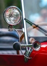 Shiny steel horn on red vintage car, closeup detail, only metal rim in focus Royalty Free Stock Photo