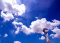 Shiny steel smokestack and cloud in sky