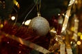 Shiny tinsels and bauble on Christmas tree, closeup Royalty Free Stock Photo
