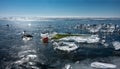 Shiny transparent ice shards are scattered over the frozen lake