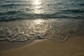 Shiny tropic sea wave on golden beach sand in sunset light,lipe
