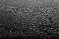 Shiny water drops on a dark glass. Water drops on black surface Royalty Free Stock Photo