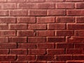 Shiny wet red painted stone brick wall alley warehouse chimney stack house exterior building retro light closeup Royalty Free Stock Photo