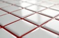 Shiny white ceramic tiles with red grout, shot from angle. Square tile flooring wall with smooth surface. Interior design, Royalty Free Stock Photo