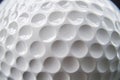 Shiny white golf ball surface with regular dimples creating a textured pattern Royalty Free Stock Photo