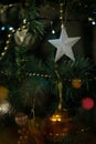 Shiny white star hanging on a decorated christmas tree. Close up. Royalty Free Stock Photo